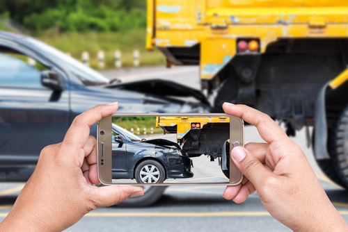 A picture being taken from a phone of a truck accident to gather evidence after a truck accident