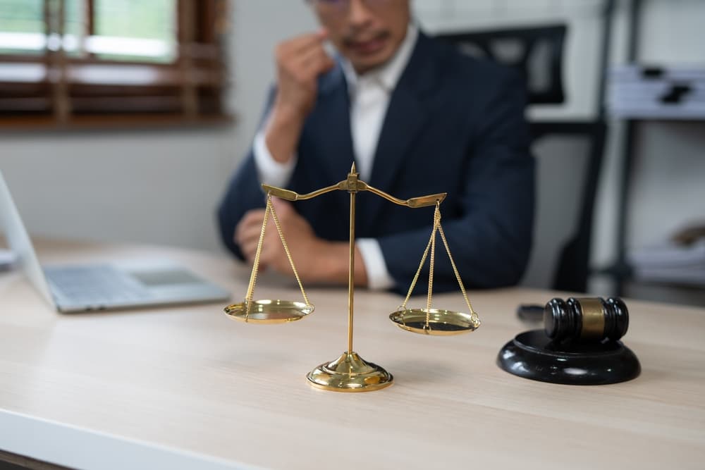 Lawyers discussing a contract agreement with business partners, preparing to sign and secure the deal in an office setting.