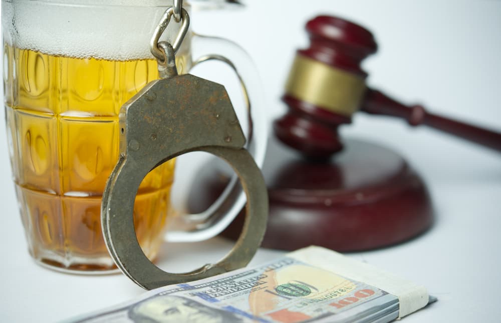 A beer mug, handcuffs, and gavel represent legal consequences of DUI charges, even on bikes.